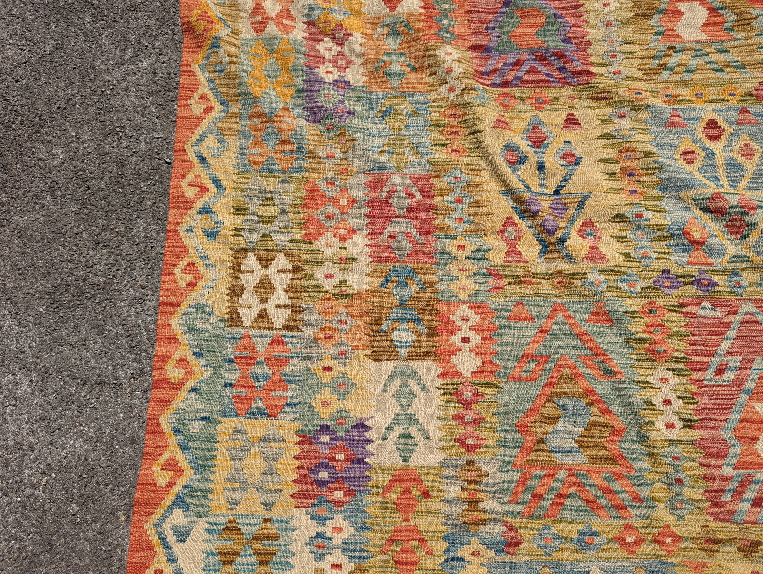 An Anatolian polychrome geometric flatweave Kilim carpet, 290 x 210cm